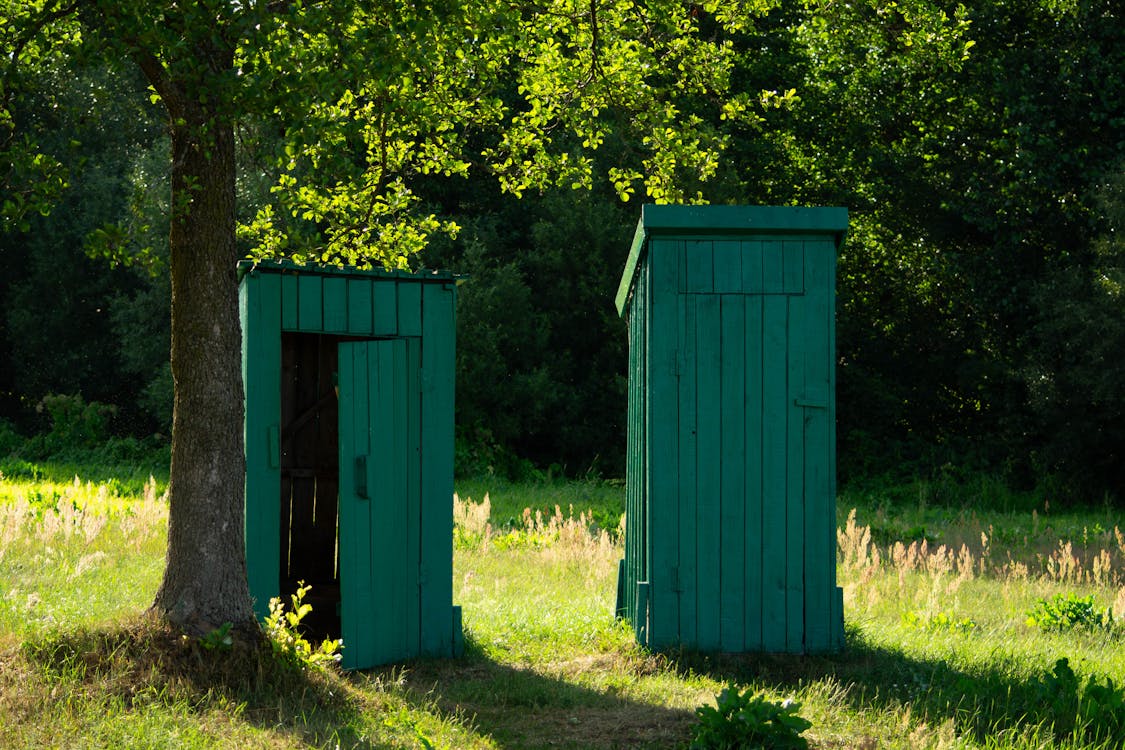 Free Small Wooden Huts on the Field  Stock Photo