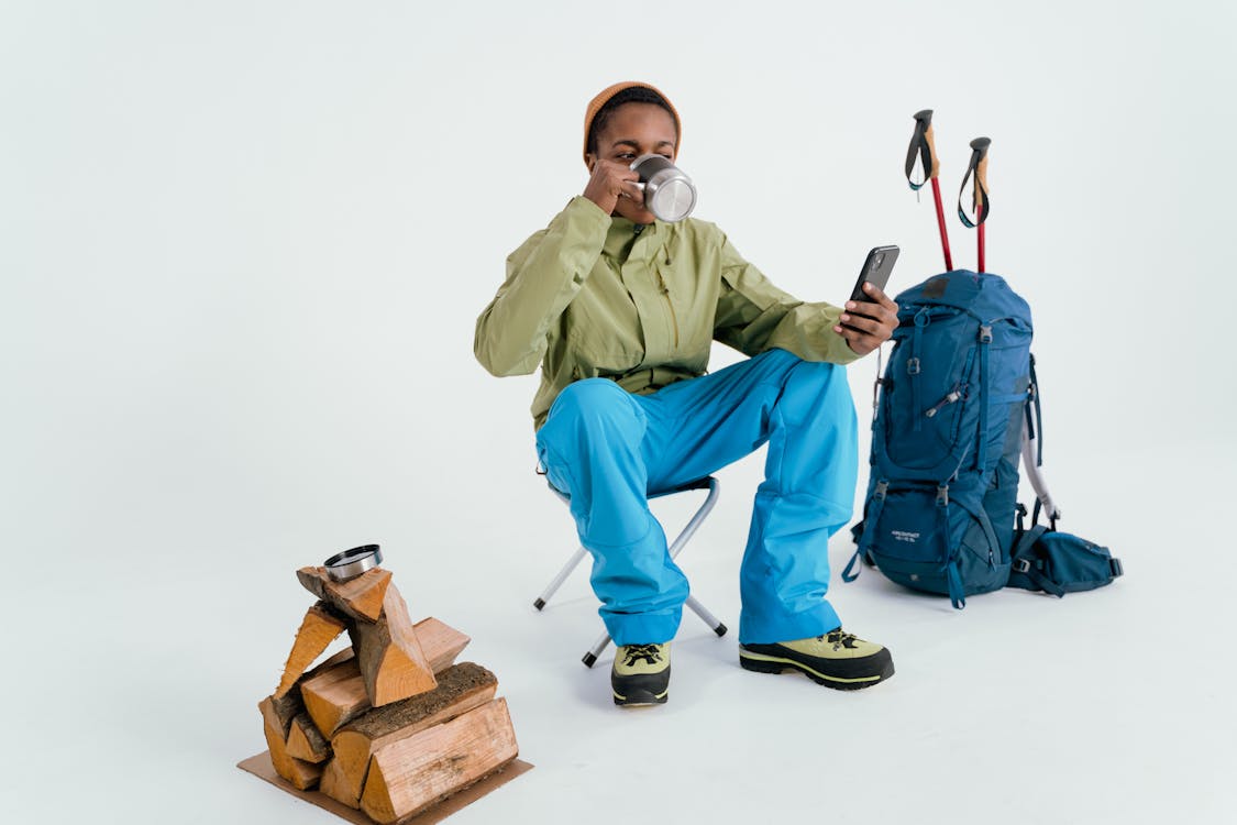 Free Man in Green Dress Shirt and Blue Pants Holding Brown Box Stock Photo